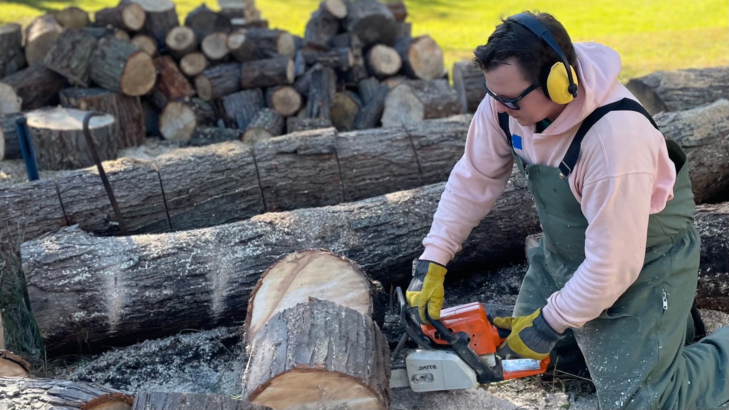 Man cutting logs